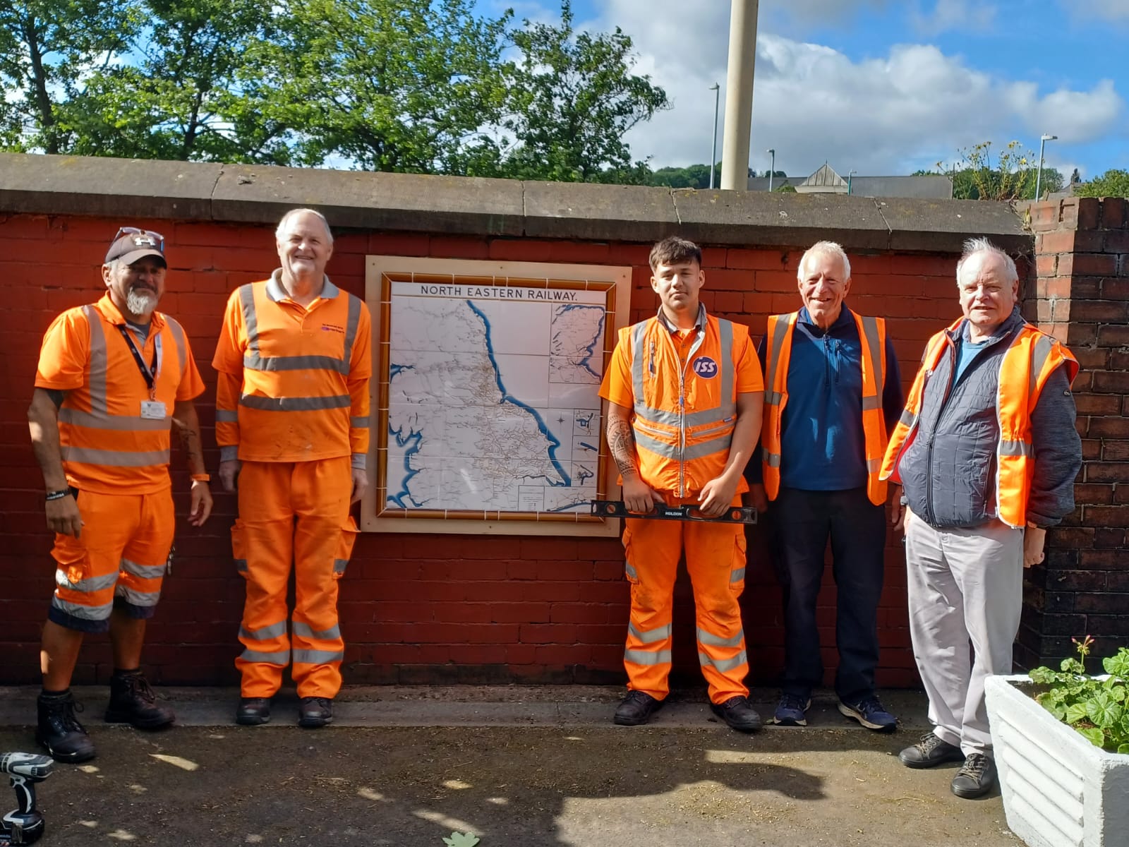 Members of the Friends of Blaydon Station and the ISS team install the map